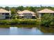 A peaceful backyard with a serene lake view surrounded by lush greenery and well-maintained landscaping at 7657 Caponata Blvd, Seminole, FL 33777
