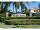 Elegant community entrance sign at Hidden Bayou amidst lush greenery and manicured landscaping at 7657 Caponata Blvd, Seminole, FL 33777