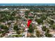 Aerial view of a residential home featuring a private pool, mature trees, and a well-maintained neighborhood at 8763 Matthew St, Seminole, FL 33772