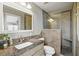 This bathroom features a gorgeous tiled shower with a built-in seat, and granite countertops at 8763 Matthew St, Seminole, FL 33772
