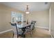 Traditional dining room with a unique tile-top table set with seating for six under elegant chandelier at 8763 Matthew St, Seminole, FL 33772