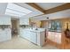 Spacious kitchen featuring modern appliances and finishes with an eat-in counter and view to outdoor patio at 8763 Matthew St, Seminole, FL 33772