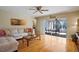 Open living room featuring hardwood floors and a view to screened porch at 8763 Matthew St, Seminole, FL 33772