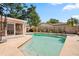 Backyard pool with a concrete pool deck, screen enclosure and wood fence for added privacy at 8763 Matthew St, Seminole, FL 33772