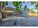 Backyard of the home, featuring a patio area with gravel and a small tree in a pot at 905 W Ball St, Plant City, FL 33563