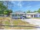 View of the front of the home, showing a small yard with chain link fence and nearby street at 905 W Ball St, Plant City, FL 33563