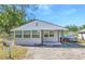 Charming single-story home featuring a cozy front porch and a well-maintained front yard at 905 W Ball St, Plant City, FL 33563