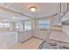Bright kitchen with gray cabinets, granite countertops, and an adjoining dining area at 905 W Ball St, Plant City, FL 33563