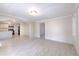 Open-concept living space showcasing gray tile flooring and views of the kitchen at 905 W Ball St, Plant City, FL 33563