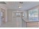 Open-concept living room featuring wood look ceramic tile flooring and lots of natural light at 905 W Ball St, Plant City, FL 33563