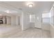 Open-concept living room boasts light, neutral paint, bright lighting, and updated floors at 905 W Ball St, Plant City, FL 33563