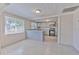 Open-concept living space showcasing gray tile flooring and views of the kitchen at 905 W Ball St, Plant City, FL 33563