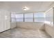 Sun room with multiple windows and gray tile flooring at 905 W Ball St, Plant City, FL 33563