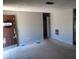 View of the living room showing damaged door at 9355 Pinero St, Spring Hill, FL 34608