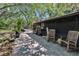 Covered back patio with brick pavers, chairs, and various plants at 9724 Hermit Hollow Ln, Gibsonton, FL 33534