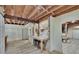 Open bar area features a marble countertop, stools, and exposed beams, ideal for entertaining guests at 9724 Hermit Hollow Ln, Gibsonton, FL 33534