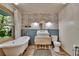 Charming bathroom with vintage-style clawfoot tub and sink with wood accents at 9724 Hermit Hollow Ln, Gibsonton, FL 33534