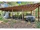 Outdoor carport features a truck and open space for storage of equipment and materials at 9724 Hermit Hollow Ln, Gibsonton, FL 33534