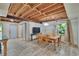 Bright dining area with a rustic table, wooden chairs, and exposed ceiling beams, perfect for Gathering meals at 9724 Hermit Hollow Ln, Gibsonton, FL 33534