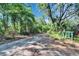 A driveway winding through a beautiful landscape at 9724 Hermit Hollow Ln, Gibsonton, FL 33534