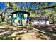 Charming two-story home with a lush, green lawn and mature trees at 9724 Hermit Hollow Ln, Gibsonton, FL 33534
