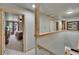 Upstairs hallway leads to a bedroom and other spaces in the home at 9724 Hermit Hollow Ln, Gibsonton, FL 33534