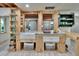 Well-lit kitchen featuring wooden shelving, white cabinetry, and a white farmhouse sink at 9724 Hermit Hollow Ln, Gibsonton, FL 33534