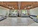 Open living room with wood plank ceiling, light grey flooring, and plenty of natural light at 9724 Hermit Hollow Ln, Gibsonton, FL 33534