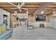Spacious living room with wood plank ceiling, light grey flooring that flows into kitchen at 9724 Hermit Hollow Ln, Gibsonton, FL 33534