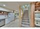 Spacious interior shows staircase and kitchen area with stainless-steel appliances at 9724 Hermit Hollow Ln, Gibsonton, FL 33534