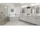 Bright bathroom features a shower, large soaking tub, a double sink vanity with a large mirror and decor at 10142 Deercliff Dr, Tampa, FL 33647