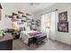 Bedroom with sports-themed decor, a ceiling fan, and a window with natural light at 10142 Deercliff Dr, Tampa, FL 33647