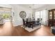 The dining area features hardwood floors, a large wall mirror, and a stylish chandelier over a large table at 10142 Deercliff Dr, Tampa, FL 33647