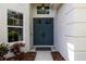 Close up of the home's double door front entrance, accompanied by a window and beautiful landscaping at 10142 Deercliff Dr, Tampa, FL 33647