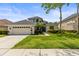 Charming two-story home with well-manicured lawn, mature landscaping, and a welcoming front entrance at 10142 Deercliff Dr, Tampa, FL 33647