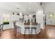 Bright kitchen featuring a breakfast bar, white cabinets, stainless steel appliances, and hardwood floors at 10142 Deercliff Dr, Tampa, FL 33647