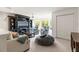 Bright living room with plush seating, a ceiling fan, an entertainment center, and windows with a backyard view at 10142 Deercliff Dr, Tampa, FL 33647