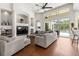 Bright and airy living room with fireplace, built-in shelving, and views of the pool and backyard at 10142 Deercliff Dr, Tampa, FL 33647