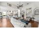 Spacious living room with high ceilings, an open floor plan, hardwood floors, and seamless transition into the kitchen at 10142 Deercliff Dr, Tampa, FL 33647