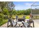 Inviting outdoor seating area with comfortable chairs arranged around a fire pit and view of the landscape at 10142 Deercliff Dr, Tampa, FL 33647