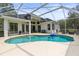 Backyard with a screened-in pool and lounge seating at 10142 Deercliff Dr, Tampa, FL 33647