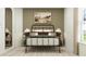 Inviting bedroom with a metal frame bed, soft bedding, and minimalist decor, creating a calming and stylish retreat at 10258 Gentle Rain Dr, Land O Lakes, FL 34638