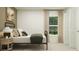 Cozy bedroom with a metal frame bed, neutral bedding, and natural light, providing a peaceful and comfortable space at 10258 Gentle Rain Dr, Land O Lakes, FL 34638