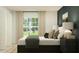 Chic bedroom with a comfortable bed, dark accent wall, and modern decor, creating a sophisticated and tranquil space at 10258 Gentle Rain Dr, Land O Lakes, FL 34638