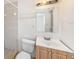 Quaint bathroom featuring a vanity, toilet, mirror, and built in shower at 1051 Normandy Blvd, Holiday, FL 34691