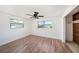 Bedroom with laminate flooring, ceiling fan, and natural light at 1051 Normandy Blvd, Holiday, FL 34691