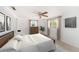 Comfortable bedroom with a ceiling fan, bright windows, and neutral decor at 1051 Normandy Blvd, Holiday, FL 34691