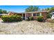 Charming single-story home featuring a quaint front porch and tidy landscaping at 1051 Normandy Blvd, Holiday, FL 34691