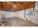Unfinished garage with exposed wood rafters and concrete floor at 1051 Normandy Blvd, Holiday, FL 34691