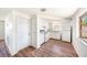 Efficient kitchen with white appliances, cabinets, and wood-look flooring at 1051 Normandy Blvd, Holiday, FL 34691